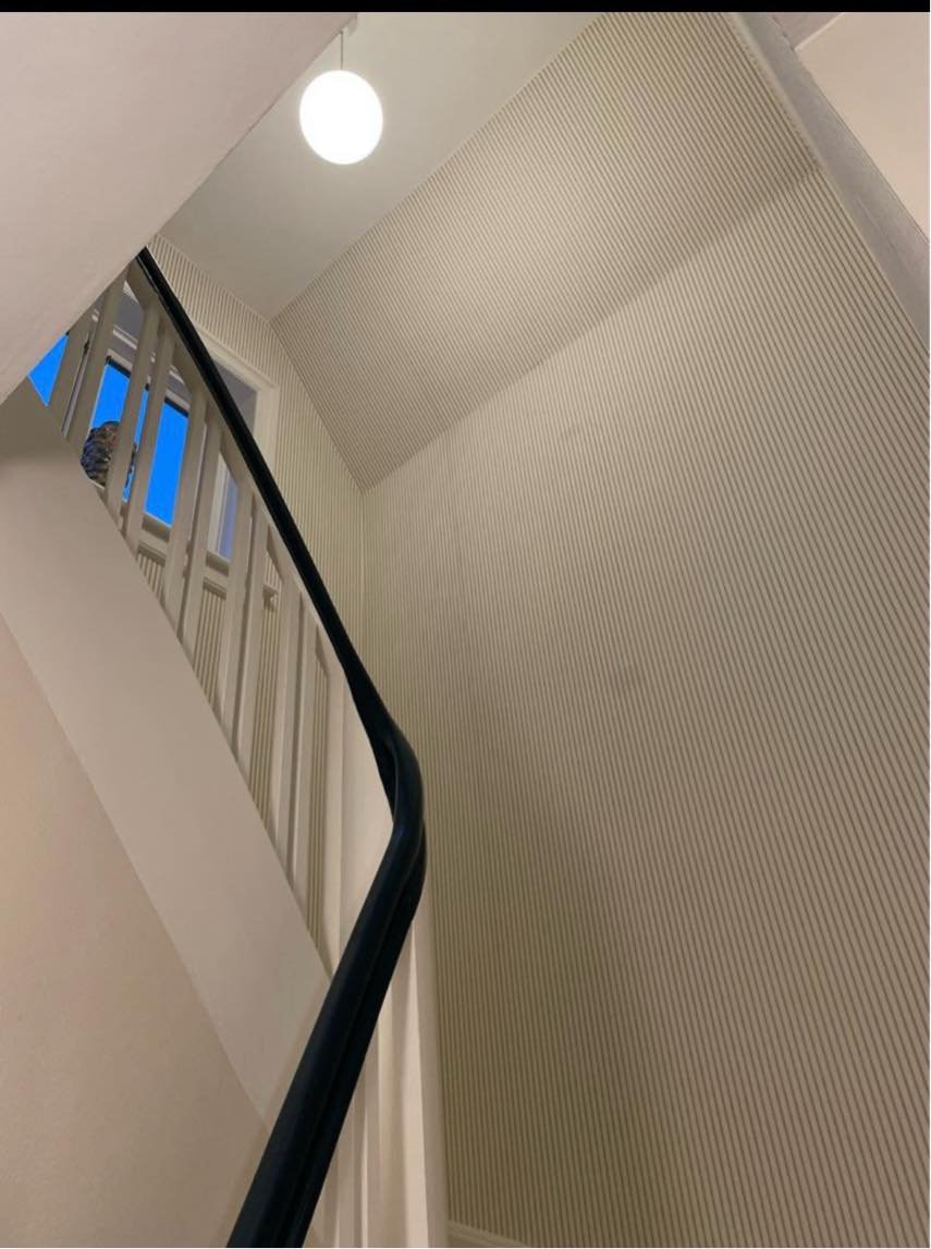 Ophæng af lampe i trappeopgang på snoet trappe
