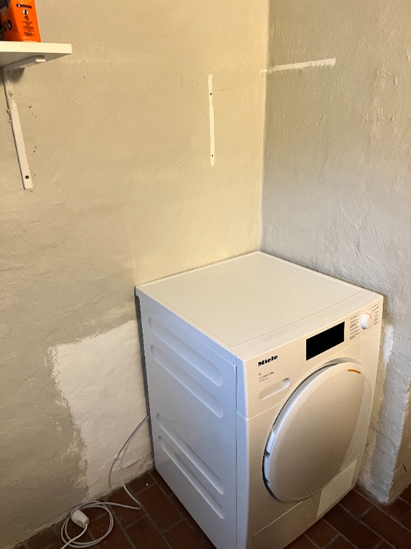 Fryser bæres ned i kælder med lavt loft