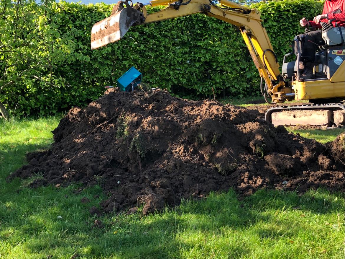 Hjælp til at fjerne jord fra nedgravning af trampolin