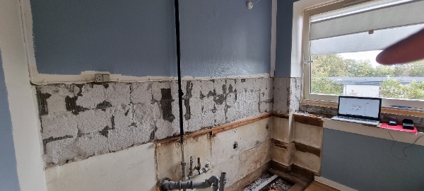 Fjerning af gammelt mørtel og pudsning af køkkenvasken.