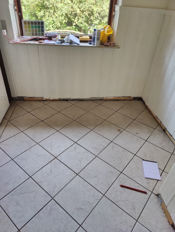 Opsætning af fodlister i lille køkken, opsætning af lamper, opsætning af vægskab