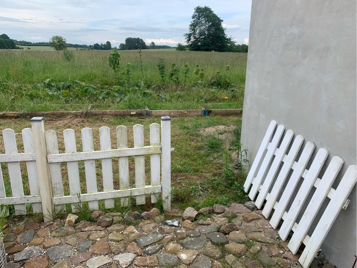 jeg har brug for hjælp til at reparere dette hegn.. det skal skæres til og fastgøres til en pæl, da bygningen har isolation udvendigt..