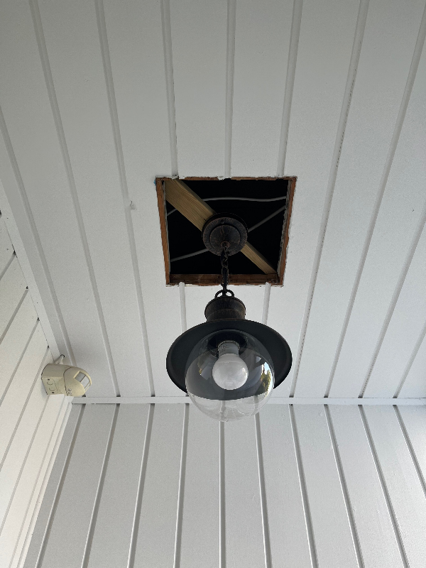 fixet et hul i udendørs indgangsparti omkring en lampe